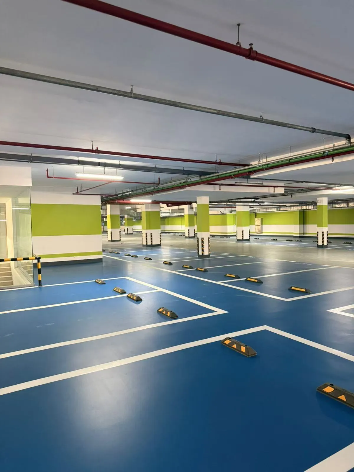 Completed blue epoxy parking floor with bay markings