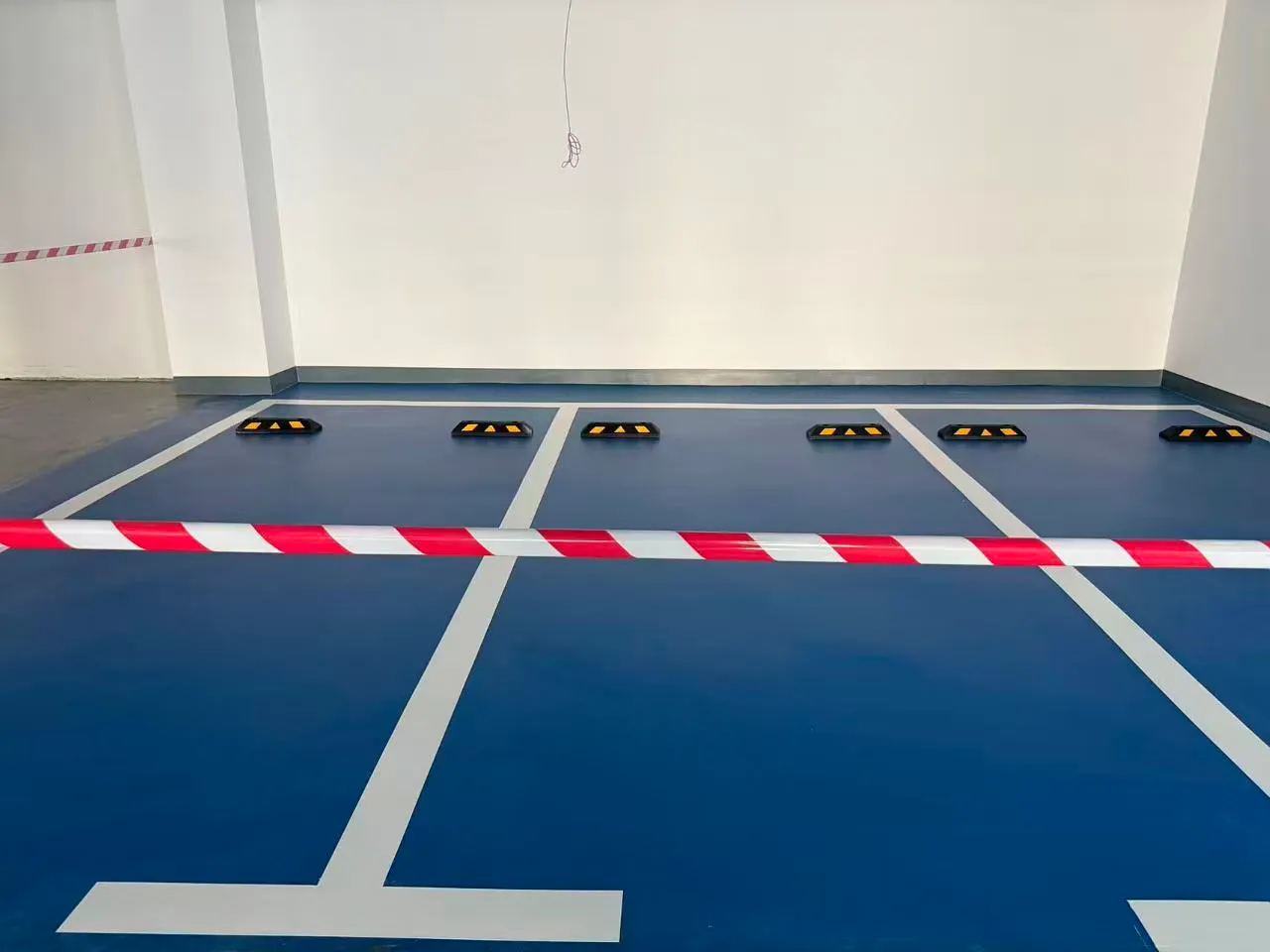 Parking floor line marking and wheel stops