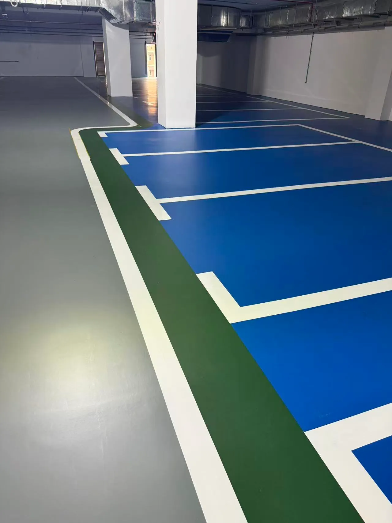 Blue epoxy parking floor with green traffic zone